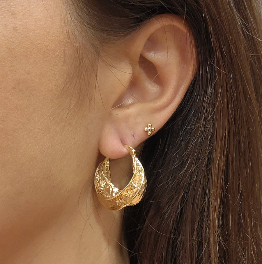 woman wearing gold plated earrings