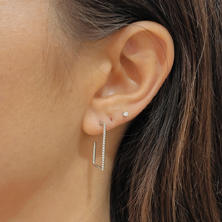 woman wearing silver earrings