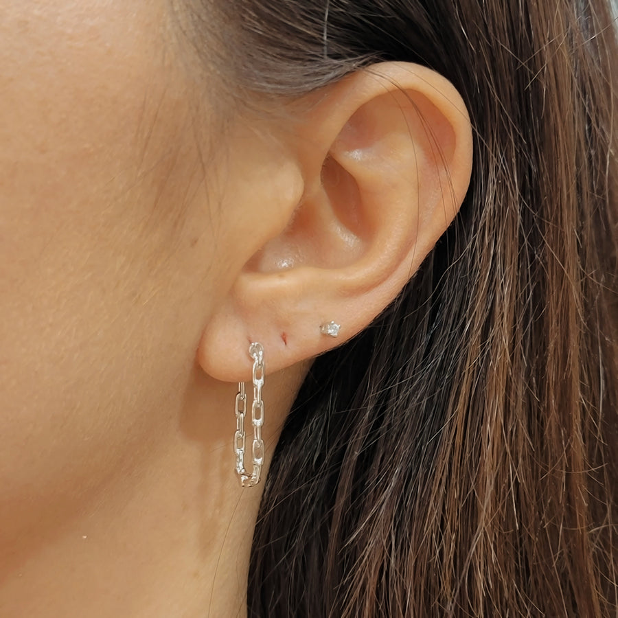 woman wearing silver earrings