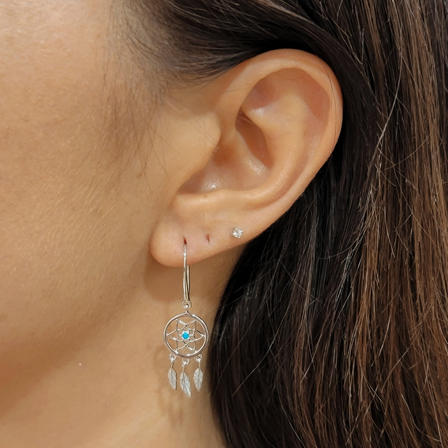 woman wearing silver earrings