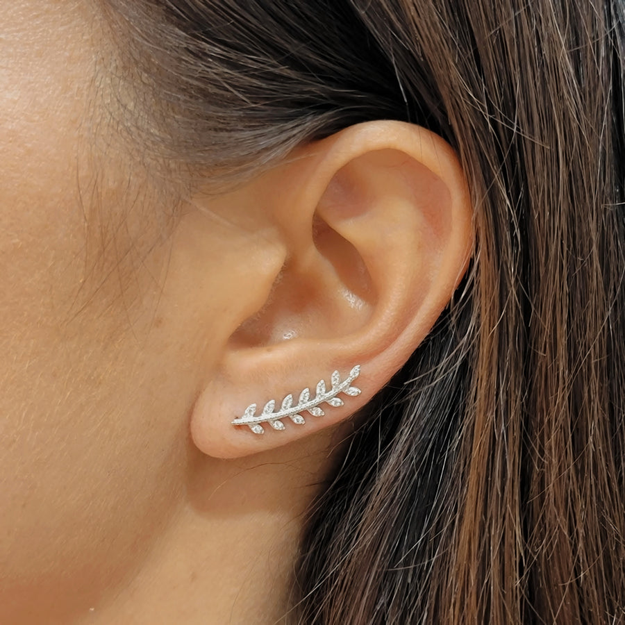 woman wearing silver ear climbers