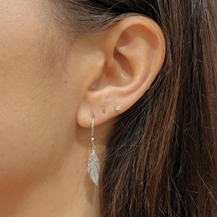 woman wearing silver earrings