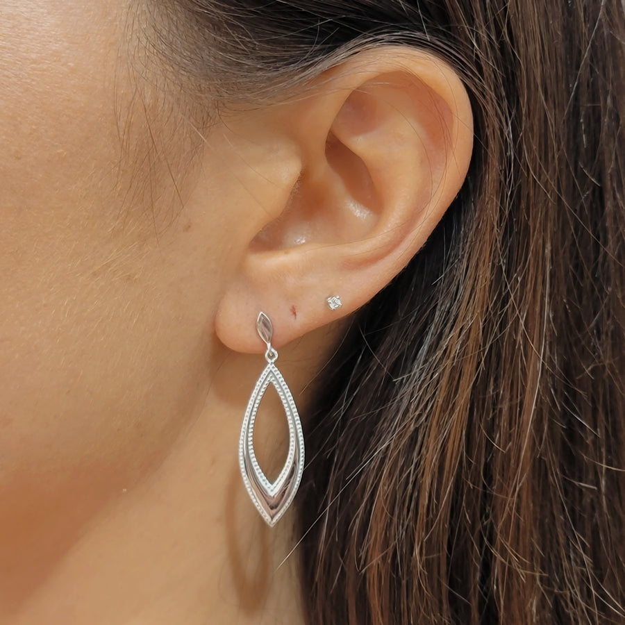 woman wearing silver earrings