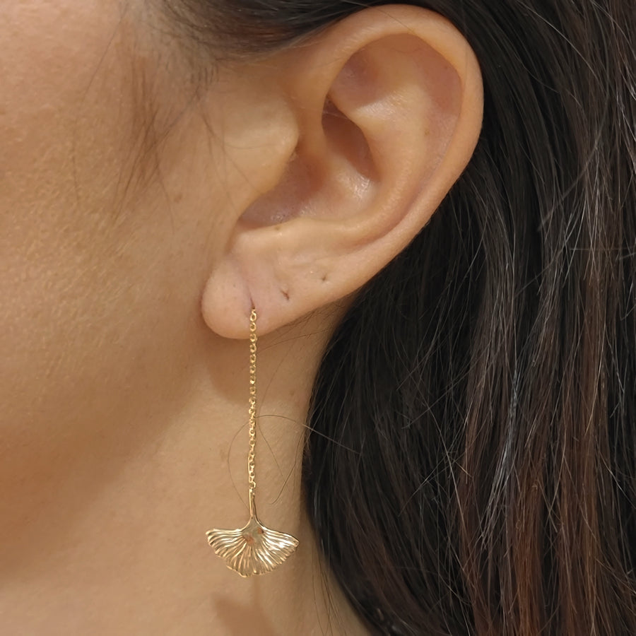 woman wearing gold plated earrings