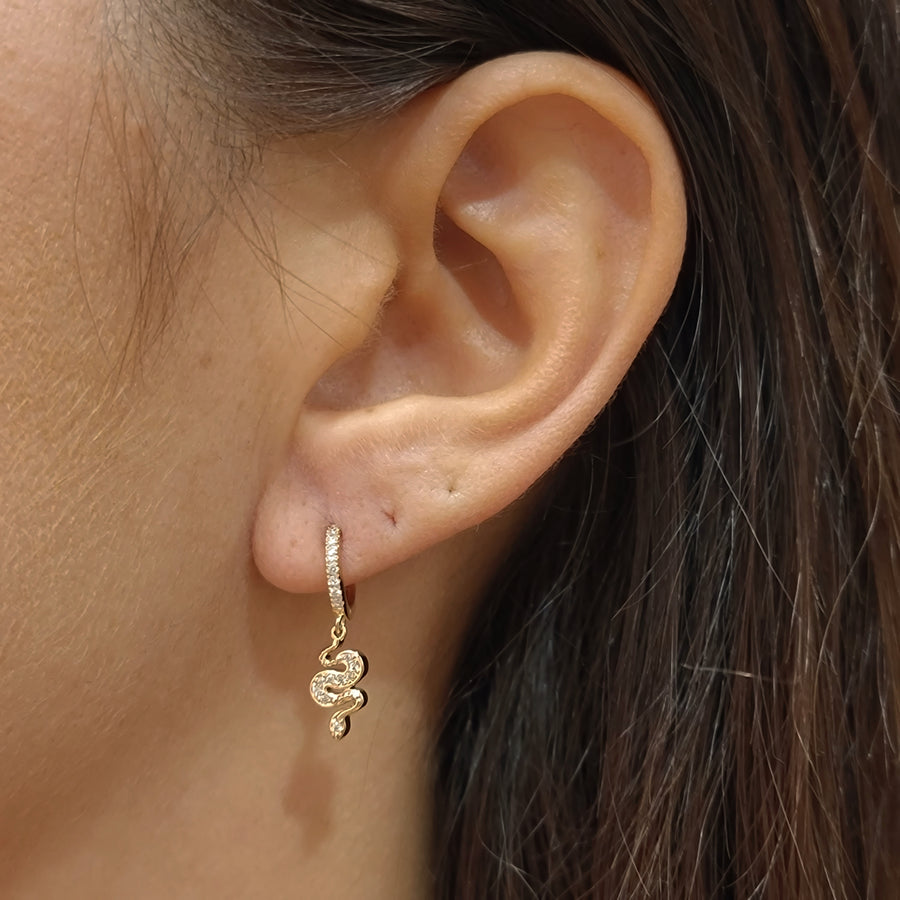 woman wearing gold plated earrings