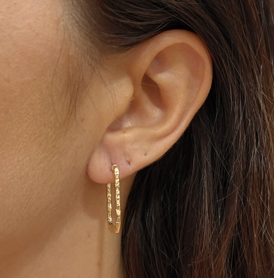 woman wearing gold plated earrings