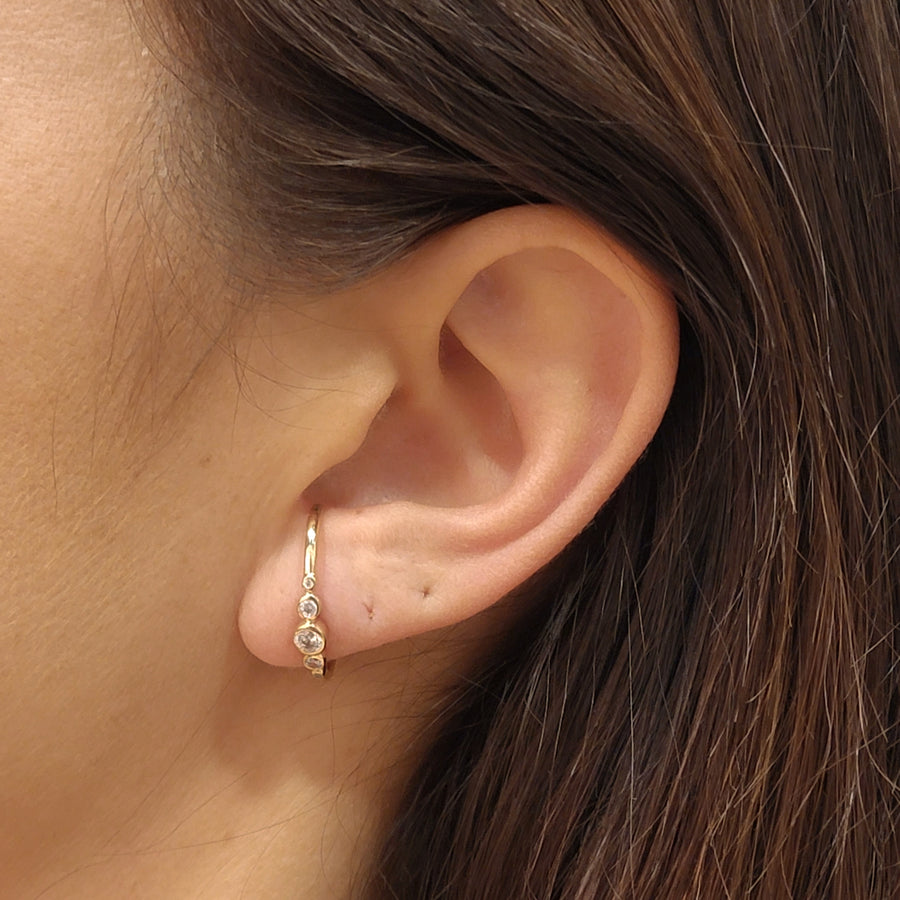 woman wearing gold plated earrings