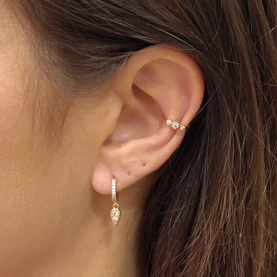 woman wearing gold plated earrings