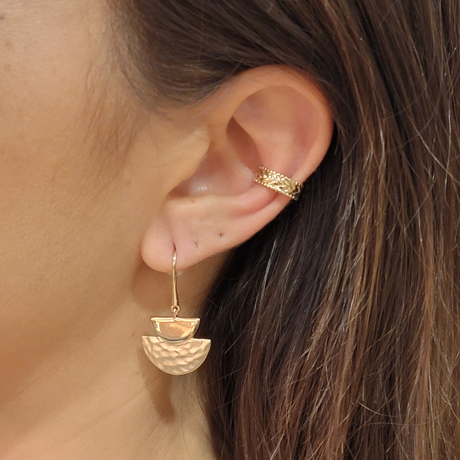 woman wearing gold plated earrings