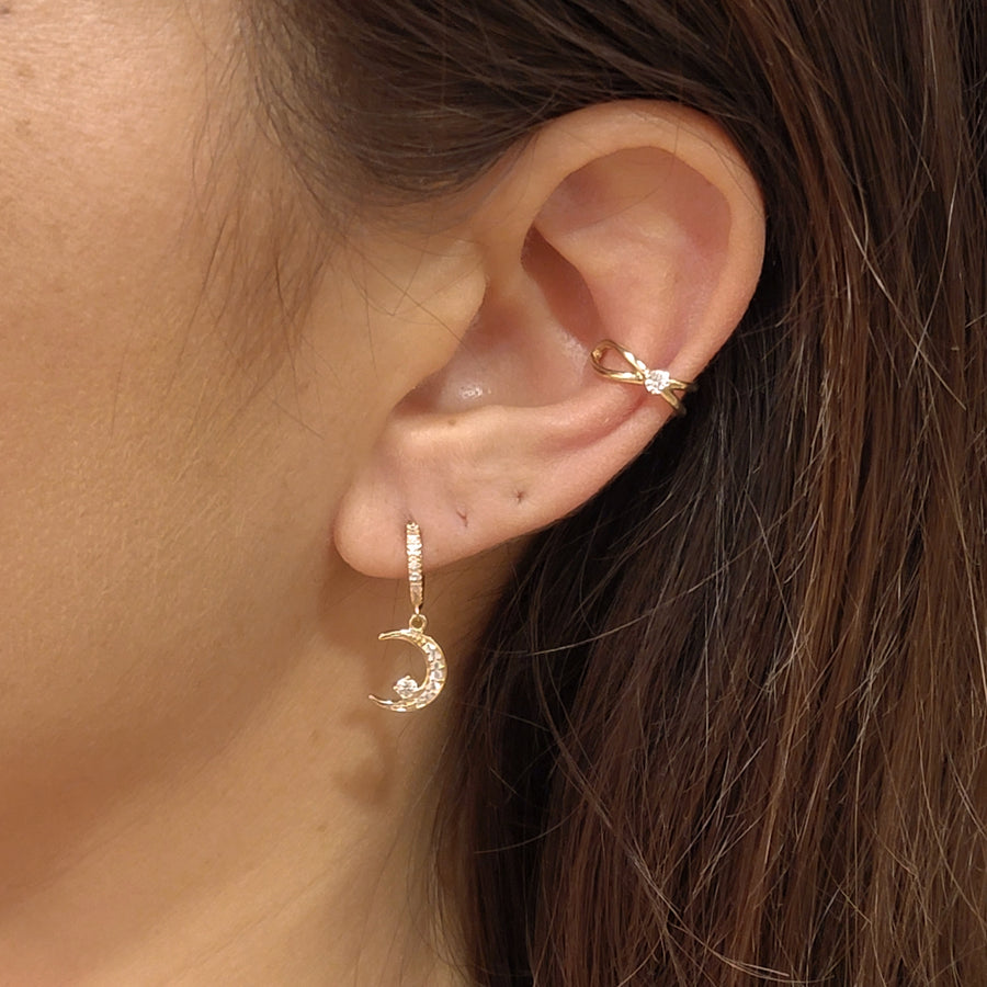 woman wearing gold plated earrings