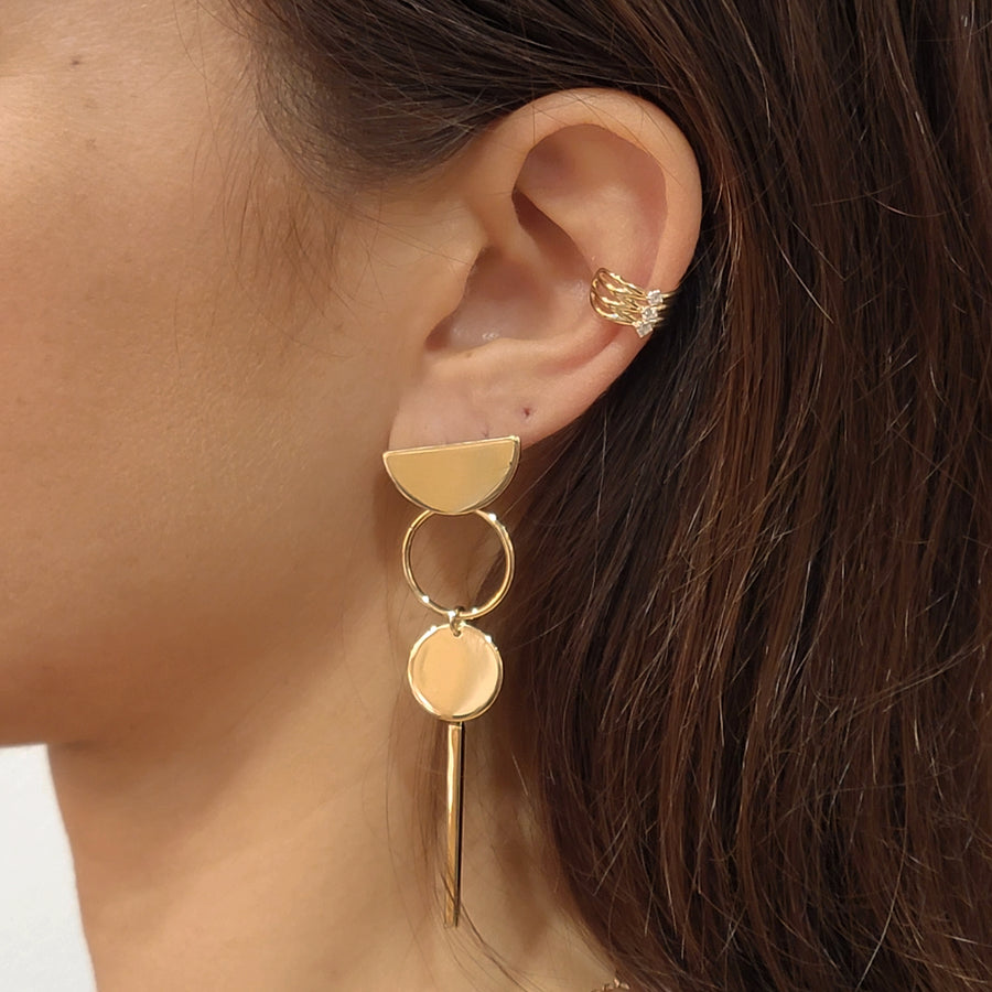 woman wearing gold plated earrings