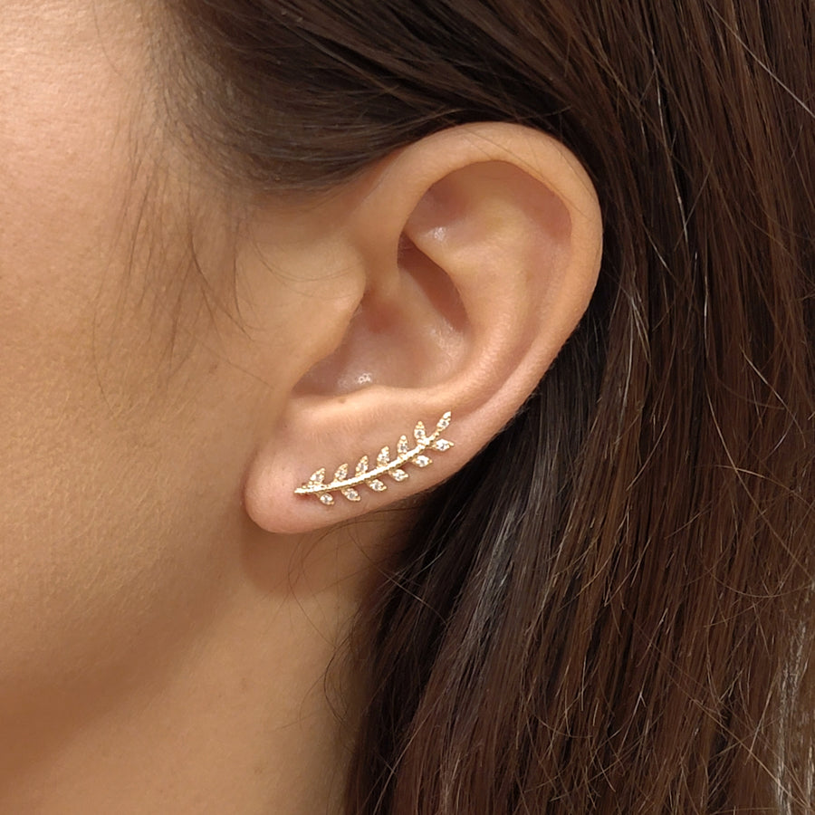 woman wearing gold plated earrings