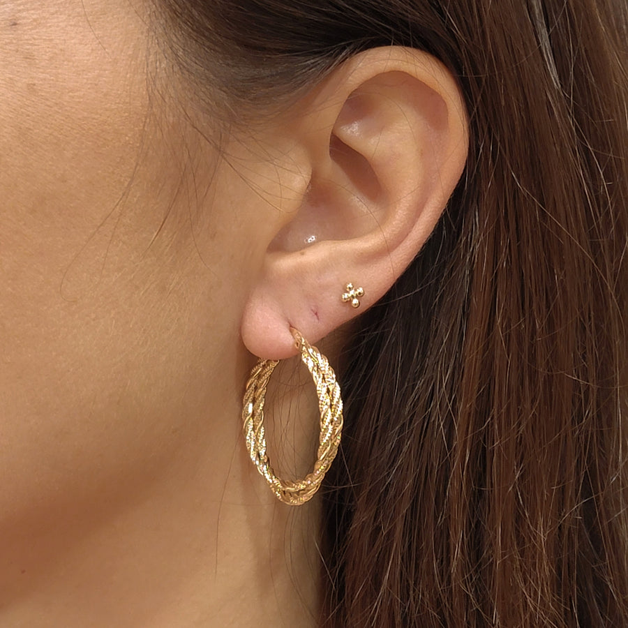 woman wearing gold plated earrings