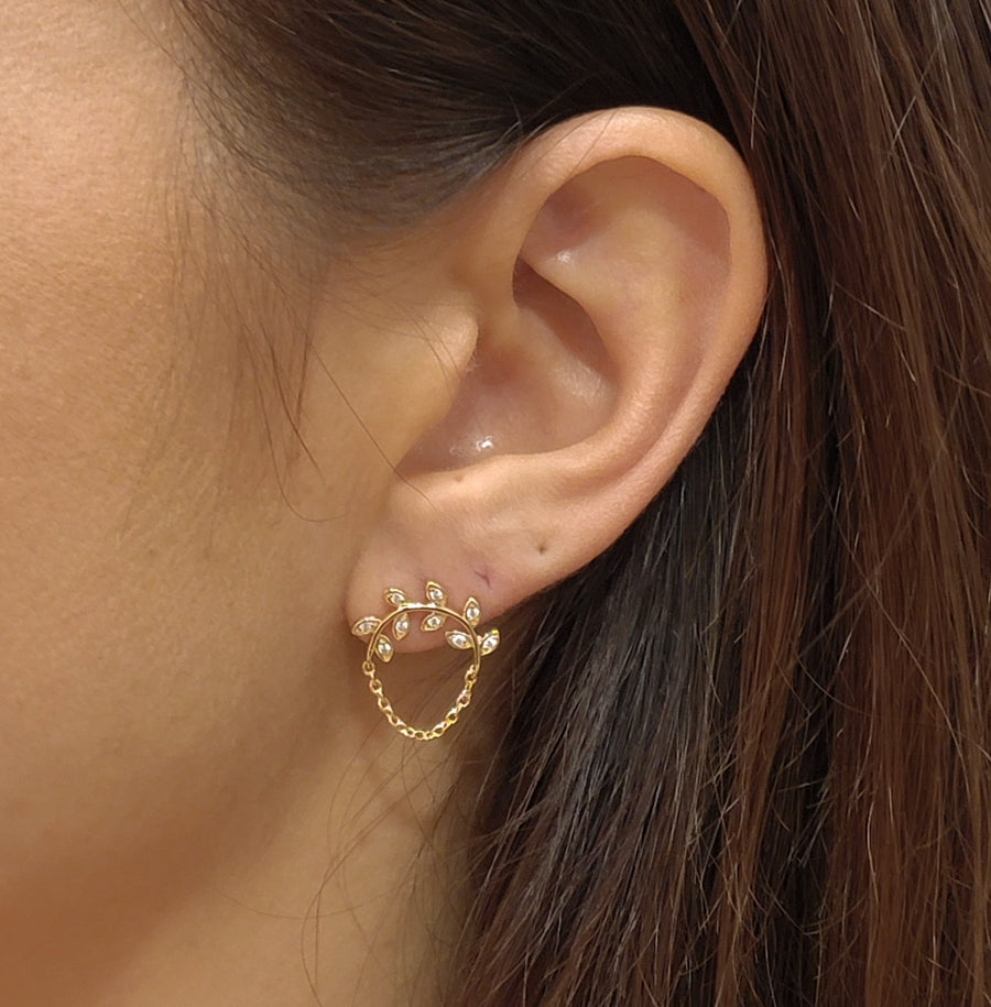 woman wearing gold plated earrings