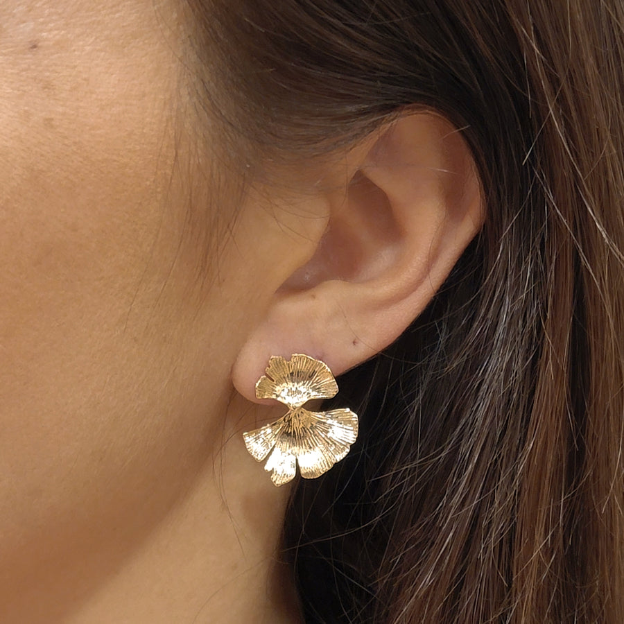 woman wearing gold plated earrings