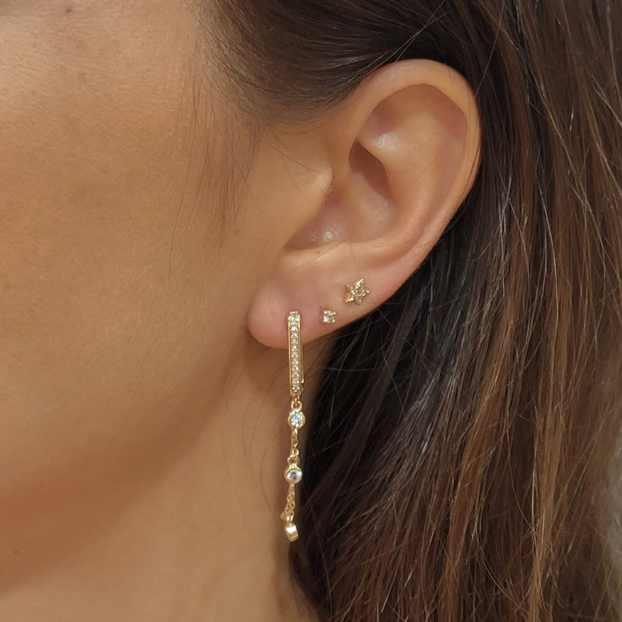 woman wearing gold plated earrings