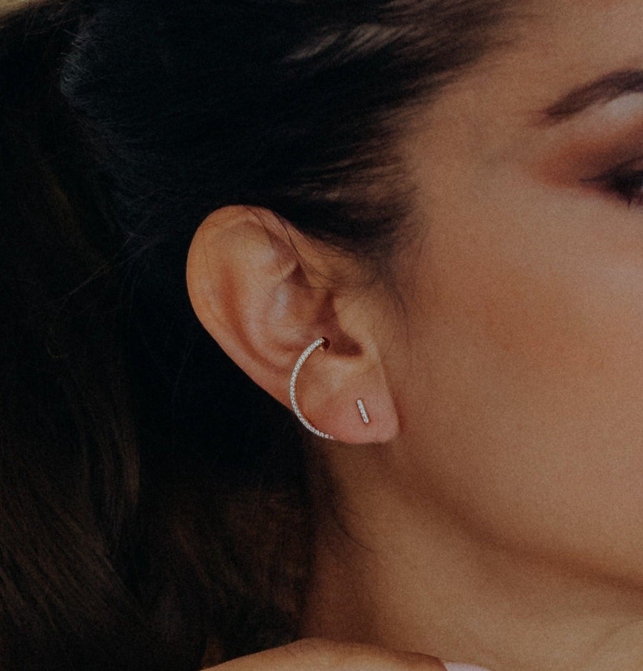 woman wearing gold plated earrings